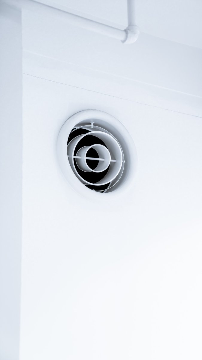Security camera installed high on a building wall
